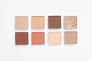Beautiful eye shadow refill pans on white background, flat lay