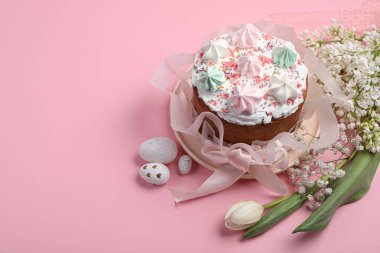 Traditional Easter cake with meringues and painted eggs on pink background, space for text