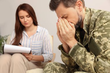 Psychologist working with military officer in office