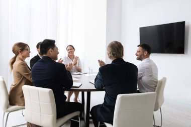 Business conference. Group of people watching presentation on tv screen in meeting room
