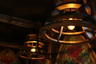 Stylish pendant lamps on ceiling in hotel room