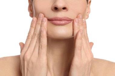 Woman massaging her face on white background, closeup