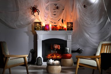 Room with fireplace decorated for Halloween. Festive interior