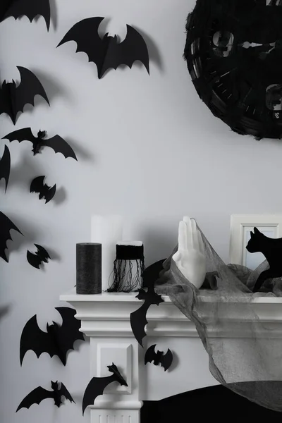 Different Halloween decor on fireplace in room