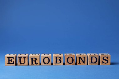 Word Eurobonds made of wooden cubes with letters on blue background