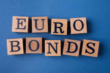 Word Eurobonds made of wooden cubes with letters on blue background, flat lay