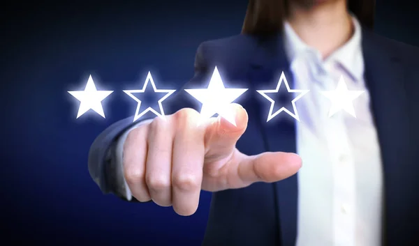 Quality rating. Woman pointing at stars on virtual screen against dark background, closeup