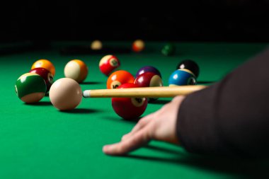 Man playing billiard at green table, closeup