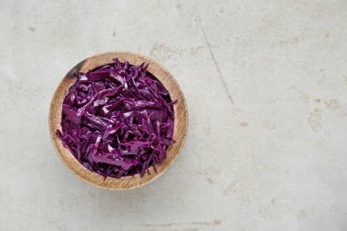 Tasty red cabbage sauerkraut on table, top view. Space for text