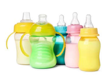 Feeding bottles with milk on white background