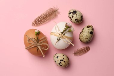 Festively decorated eggs on pink background, flat lay. Happy Easter