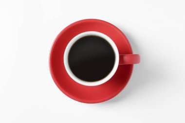 Red cup with aromatic coffee on white background, top view