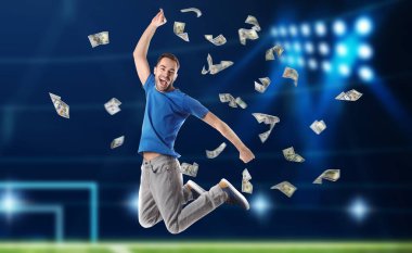 Sports betting. Happy man jumping under money shower. Stadium on background