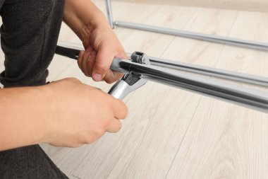 Worker installing new metal pipes indoors, closeup