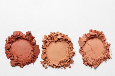 Different crushed eye shadows on white background, top view