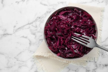 Tasty red cabbage sauerkraut on white marble table, top view. Space for text