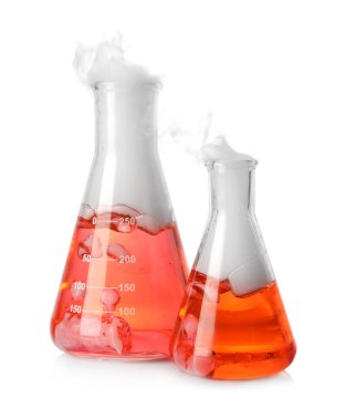 Laboratory flasks with colorful liquids and steam isolated on white. Chemical reaction