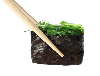 Chopsticks with delicious sushi isolated on white