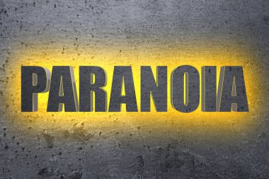Mental disorder. Illuminated word Paranoia on grey stone background