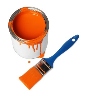 Can of orange paint and brush on white background, above view