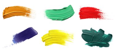Set with strokes of colorful oil paints on white background, top view