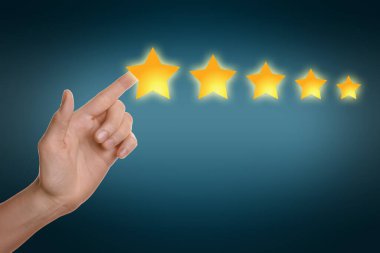 Quality rating. Woman pointing at stars against blue background, closeup
