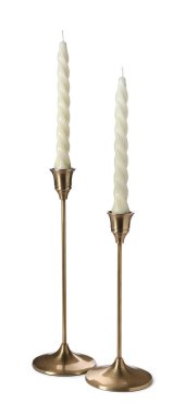 Vintage metal candlesticks with candles on white background