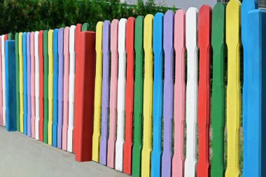 Colorful wooden fence on sunny day outdoors