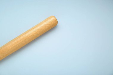 Wooden baseball bat on light grey background, top view. Space for text