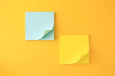 Blank paper notes on orange background, flat lay