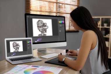 Animator working with graphic tablet, computer and laptop. Illustrations on screens clipart