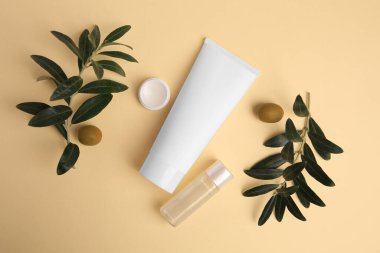 Different cosmetic products and ingredient on beige background, flat lay