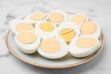 Fresh hard boiled eggs on white marble table