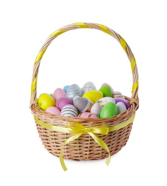 Wicker basket with beautifully painted Easter eggs isolated on white