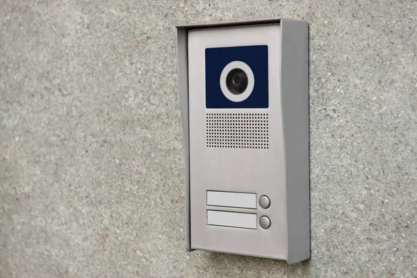 Home security system on light grey wall. Space for text