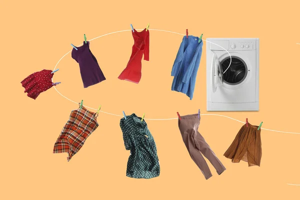 Drying laundry. Rope with different clothes flying out from washing machine on pale orange background