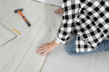 Profesyonel işçi yeni kaplama döşemeler kuruyor, kapatılıyor