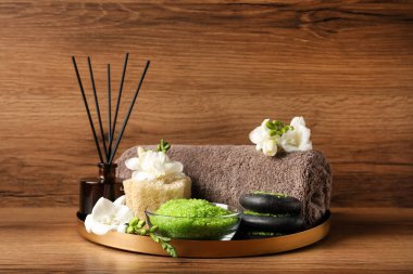 Aromatic sea salt and spa products on wooden table