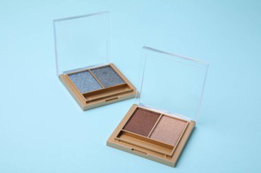 Beautiful eye shadow palettes on light blue background