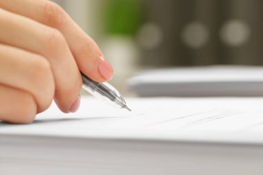 Woman signing document, closeup view. Space for text