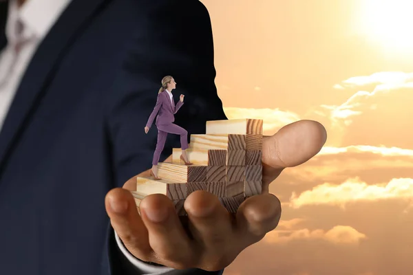 Steps to success. Businesswoman climbing up stairs of wooden blocks. Man holding stairway in sky, closeup