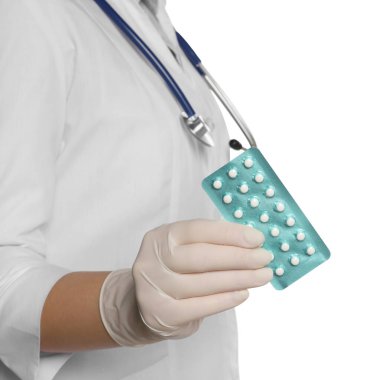 Doctor holding blister of oral contraception pills on white background, closeup