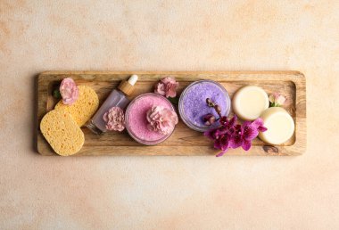 Aromatic sea salt and spa products on beige textured table, top view