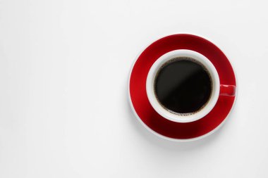 Cup with aromatic coffee on white background, top view. Space for text