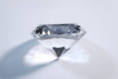 Beautiful dazzling diamond on white background, closeup