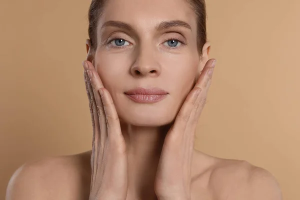 Woman Massaging Her Face Beige Background — Stock Fotó