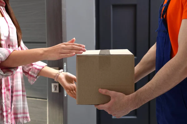 Woman Receiving Parcel Courier Home Closeup — стоковое фото
