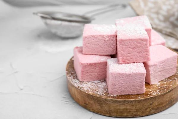 stock image Tasty marshmallows with powder sugar on white textured table, closeup. Space for text