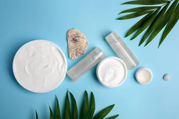 Flat Lay Composition Different Cosmetic Products Palm Leaves Light Blue — Stockfoto