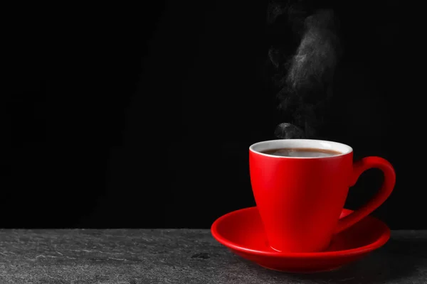 Red Cup Hot Steaming Coffee Grey Table Black Background Space — ストック写真